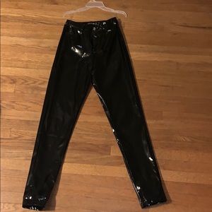 Black button front vinyl skinny pants